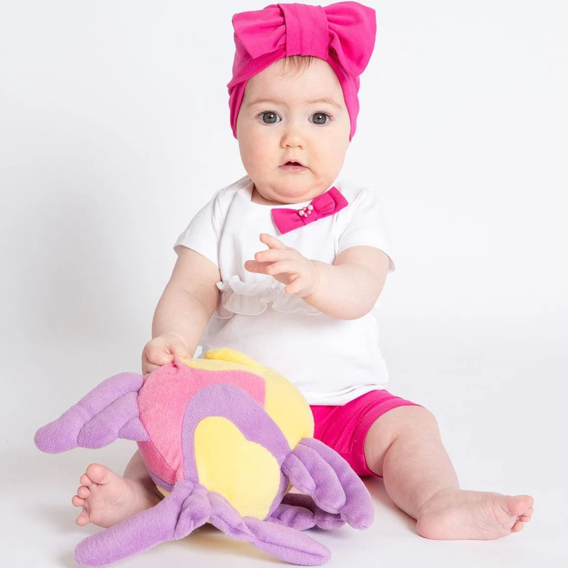 Berrettino in jersey fucsia da bambina