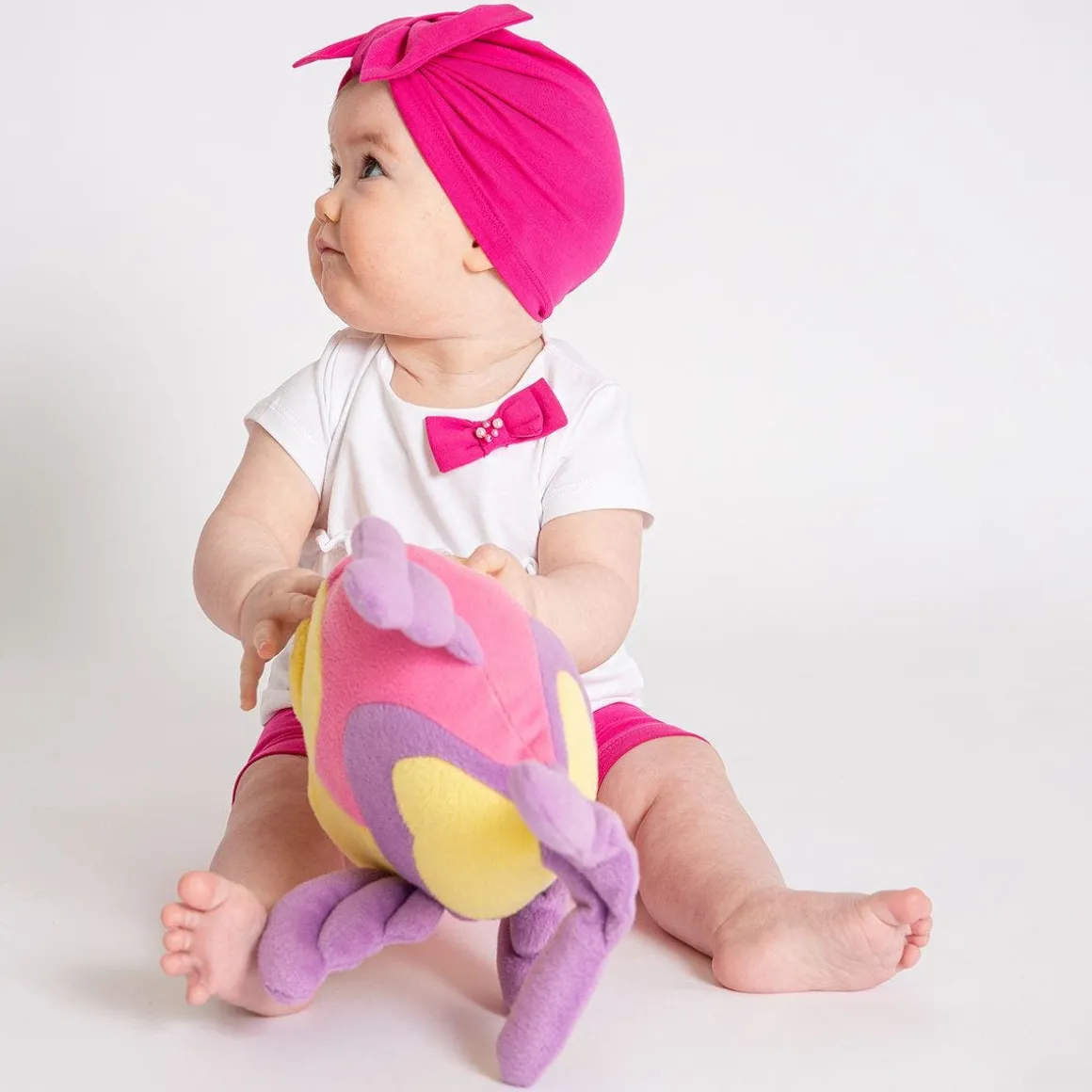 Berrettino in jersey fucsia da bambina