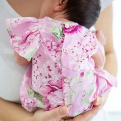 Pagliaccetto in tela stampato fiori da neonata